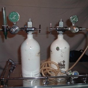 Float type oxygen regulator on the left and Positive Pressure device on the right.